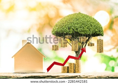 Home model and stack coin and red arrow graph and money gold coin of tree with growing the interest put on the wood in the public park, Business investment and loans for real estate concept.
