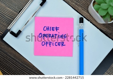 Concept of Chief Operating Officer write on sticky notes isolated on Wooden Table.