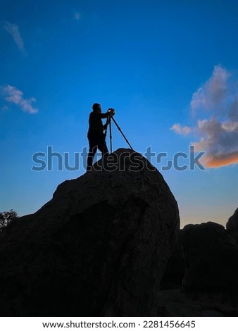 Photographer shooting sunset shot at City of Rocks, New Mexico USA.
