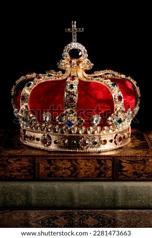 Gold Coronation Crown with Red Velevet on a Stack of Antique Books Royalty-Free Stock Photo #2281473663
