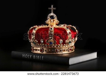 A Gold Coronation Crown with Red Velevet on a Bible Royalty-Free Stock Photo #2281473673