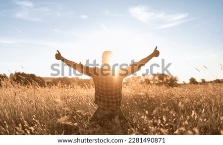 happy person young man with arms outstretched having a positive mindset	
