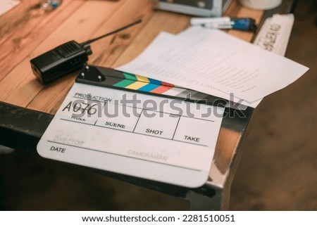 Assistant director with clapperboard on set. Close-up of firecrackers for filming a movie, advertising, TV series. Modern photography technique. Royalty-Free Stock Photo #2281510051