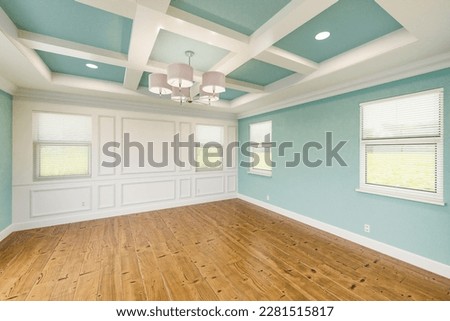 Beautiful Light Blue Custom Master Bedroom Complete with Entire Wainscoting Wall, Fresh Paint, Crown and Base Molding, Hard Wood Floors and Coffered Ceiling Royalty-Free Stock Photo #2281515817