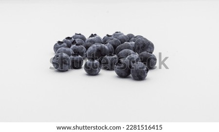 Pile of fresh blueberries isolated on white background. Selective focus.