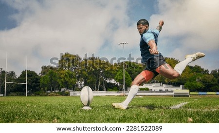 Rugby, action and man kicking ball to score goal on field at game, match or practice workout. Sports, fitness and motion, player running to kick at poles on grass with energy and skill in team sport. Royalty-Free Stock Photo #2281522089