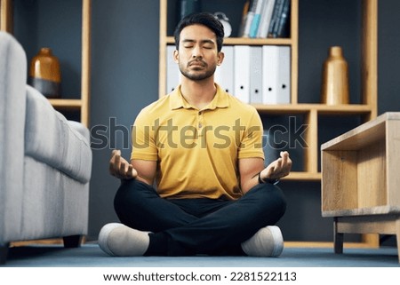 Meditation, zen and relax, man on living room floor with calm breathing exercise and time for mind wellness. Peace, balance and Indian person in lounge to meditate with concentration and mindfulness. Royalty-Free Stock Photo #2281522113