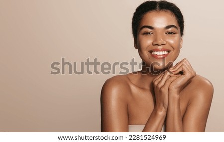 Women beauty and health. Young smiling african american girl, laughing and smiling, posing with glowing, clean and clear skin without blemishes, healthy facial glow after moisturizer, nourishing gel. Royalty-Free Stock Photo #2281524969