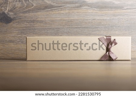 Gift box on dark wooden background