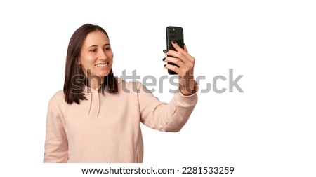 Banner size shot of a young woman taking a selfie with her smart phone.