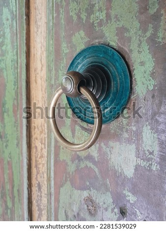 Old wooden door handle, antique and round shape. Selective focus.