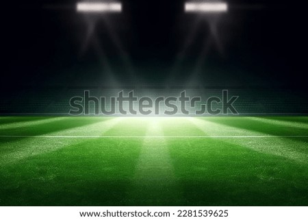 universal grass stadium illuminated by spotlights and empty green playground Royalty-Free Stock Photo #2281539625