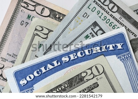 Social Security Card with cash money dollar bills - living on a fixed income, benefits SSN Royalty-Free Stock Photo #2281542179