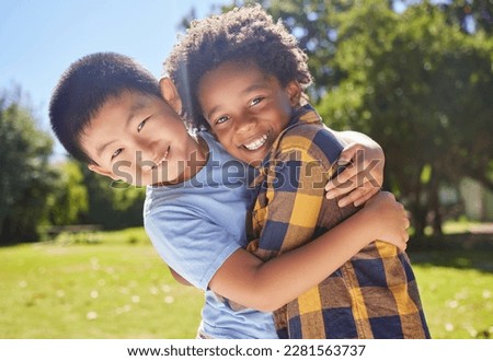 Portrait, children and friends hugging in a park together for fun, bonding or playing in summer. Hug, kids and diversity with boy best friends embracing in a garden in the day during school holidays Royalty-Free Stock Photo #2281563737