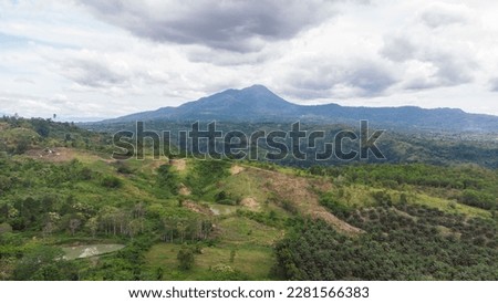 The beautiful view of Seulawah mountains towering high with dense tropical forests is visible from the air.