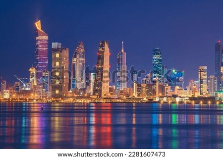 Kuwait Skyline view from beach during the national day celebration. Kuwait National day lights on the building and Kuwait flag lights during the night time. Kuwait City skyline view. Royalty-Free Stock Photo #2281607473