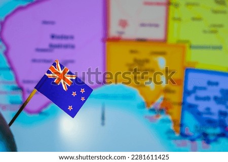 Flag of New Zealand on the background of the map.