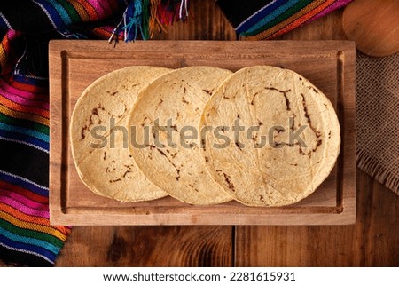 Corn Tortillas. Food made with nixtamalized corn, a staple food in several American countries, an essential element in many Latin American dishes. Royalty-Free Stock Photo #2281615931