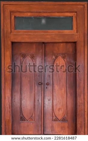 door with original wooden which has two door handles