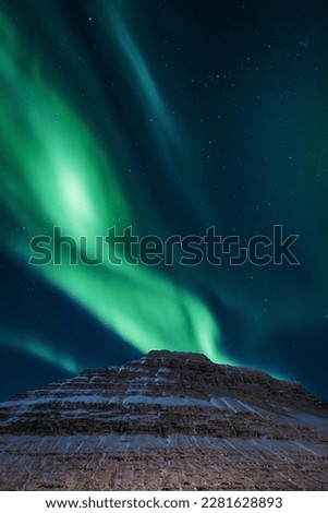 Mountain and aurora borealis at night landscape photo. Beautiful nature scenery photography with sky on background. Idyllic scene. High quality picture for wallpaper, travel blog, magazine, article