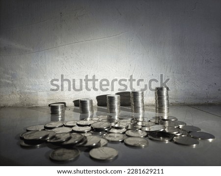 Some neatly arranged coins and some messy coins. 