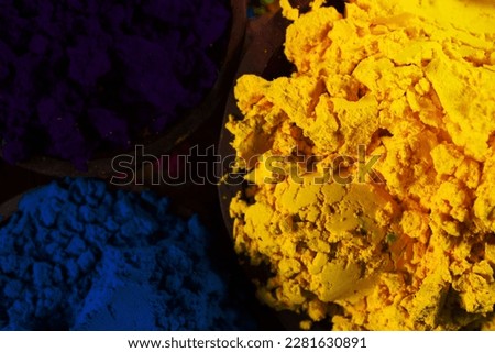 Colorful, finely powdered Indian pigments. Closeup on yellow.