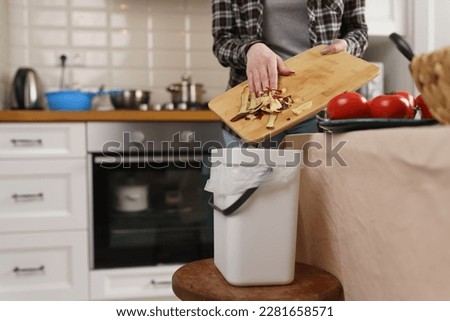 House wife cooking dinner and composting organic food waster. Woman throwing food peels into bokashi composter bin for recycling Royalty-Free Stock Photo #2281658571
