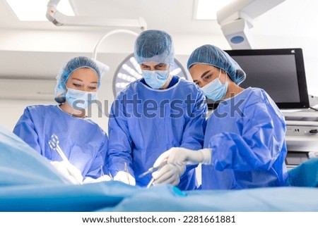 Doctor and assistant nurse operating for help patient from dangerous emergency case .Surgical instruments on the sterile table in the emergency operation room in the hospital.Health care and Medical Royalty-Free Stock Photo #2281661881