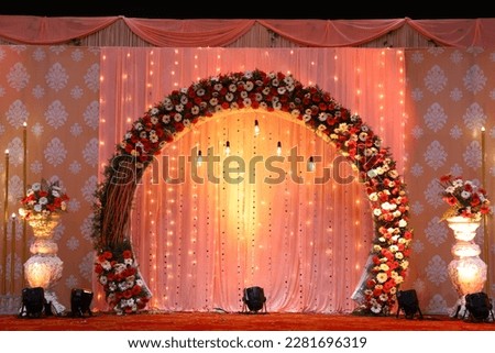 Indian stage decoration with multi color flowers, props and lights. wedding stage decoration yellow theme, with flower theme arch decor Royalty-Free Stock Photo #2281696319