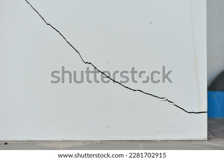 White concrete cracking wall, crack background image, white color.