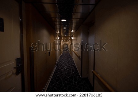 A dark photo of the inside of a cruise ship hallways