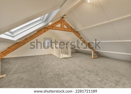 an attic room with carpet and skylights on the roof, showing how it's going to be finished Royalty-Free Stock Photo #2281721189