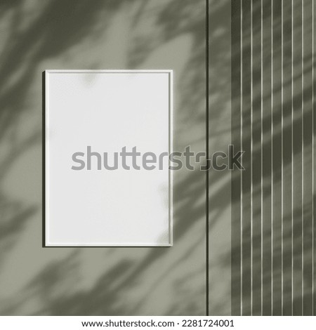 Photo frame mockup hanging on wall with shadow. Minimalist background. Blank picture frame mockup in living room.