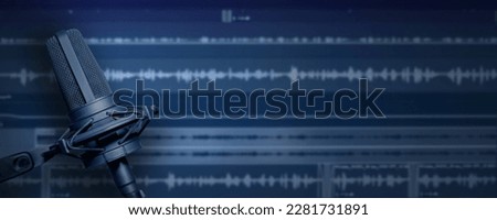 Vocal microphone with audio mixing background and copy space for recording studio banner design. Professional mic recording with audio waveform on screen. Royalty-Free Stock Photo #2281731891