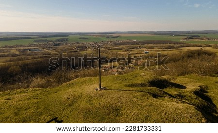 A cross and a flag on the hill in Hungary