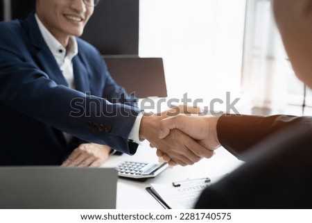 Close up two men shake hands at business meeting, office negotiations. Making deal sign, conclude contract, reach agreement, formal greeting, strike bargain. 