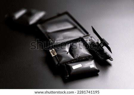 damaged laptop battery on black background