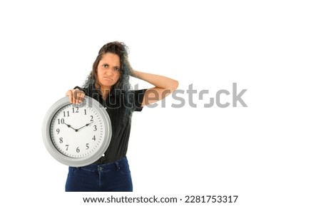 Portrait of an unhappy young arab woman holding a clock against a white background