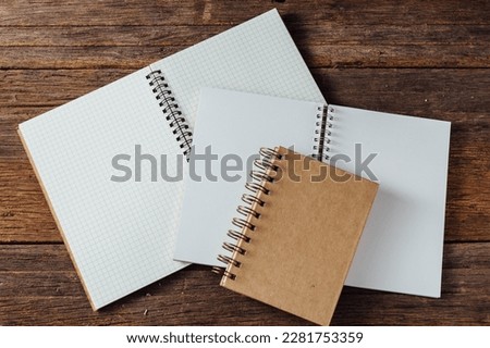 note book on wooden background