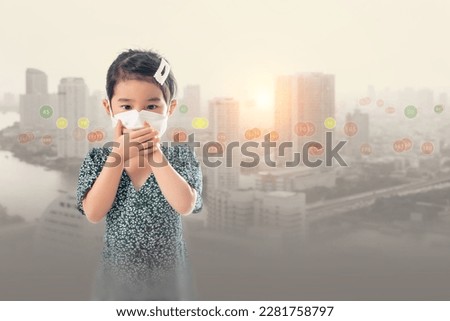 Young Asian girl wearing a mask to prevent pm.2.5 dust on a bad weather city background. Royalty-Free Stock Photo #2281758797