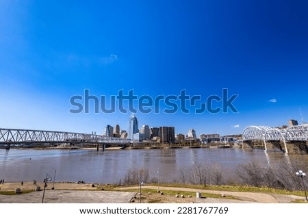 City of Cincinnati skyline as seen from the other bank of Ohio river with bridges crossing the body of water