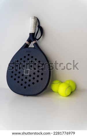 blue professional paddle tennis racket with yellow balls on white background. portrait sport theme poster, greeting cards, headers, website and app
