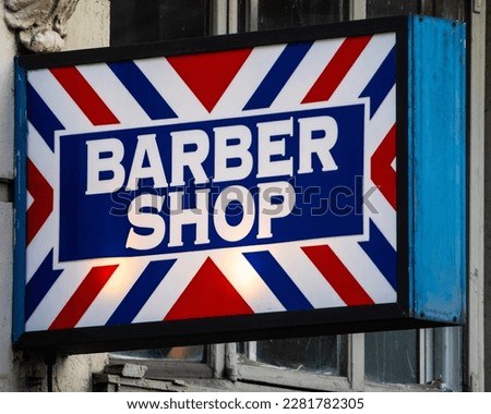 Close-up of a Barber Shop sign.