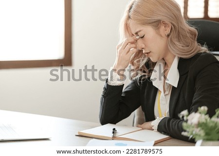 Close up on laptop in office, Asian happy beautiful businesswoman in formal suit work in workplace. Attractive female employee office worker smile.
