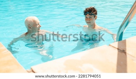 sports grandfather and grandson communicate in swimming