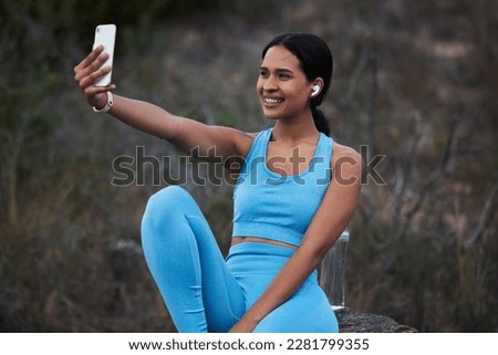 Woman outdoor, runner and fitness selfie, smile with earphones and running in nature with live streaming for social media. Exercise, cardio and happy in picture, break after run and listen to music