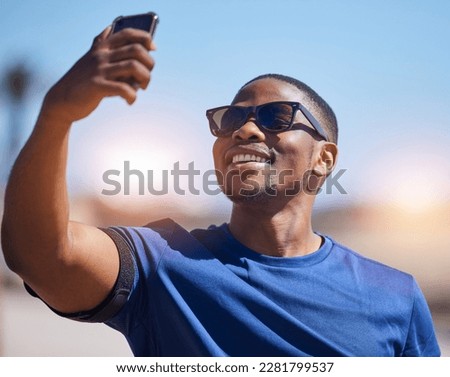 Fitness, selfie and black man runner with phone outdoor for training, running or exercise on blurred background. Happy, guy and social media health influencer smile for photo, profile picture or blog