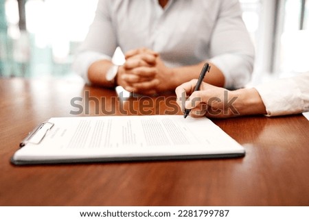 Make sure you understand the fine print before you sign anything. Closeup shot of two businesspeople going through paperwork together in an office. Royalty-Free Stock Photo #2281799787
