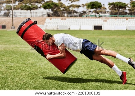 Tackle it like you mean it. a young rugby player training with a tackle bag on the playing field. Royalty-Free Stock Photo #2281800101