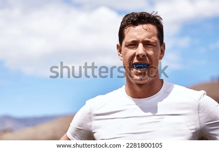 No gum bruises for me. Portrait of a young man wearing a gum guard while playing a game of rugby. Royalty-Free Stock Photo #2281800105